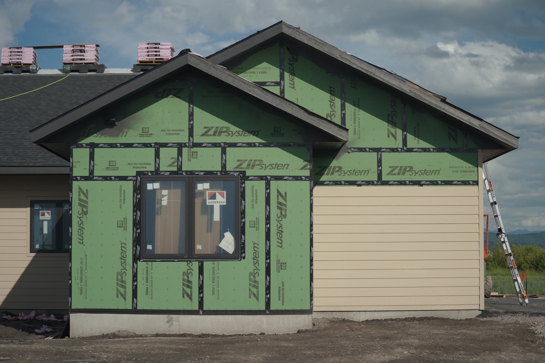 Kalispell custom home builder installing siding on modern farmhouse