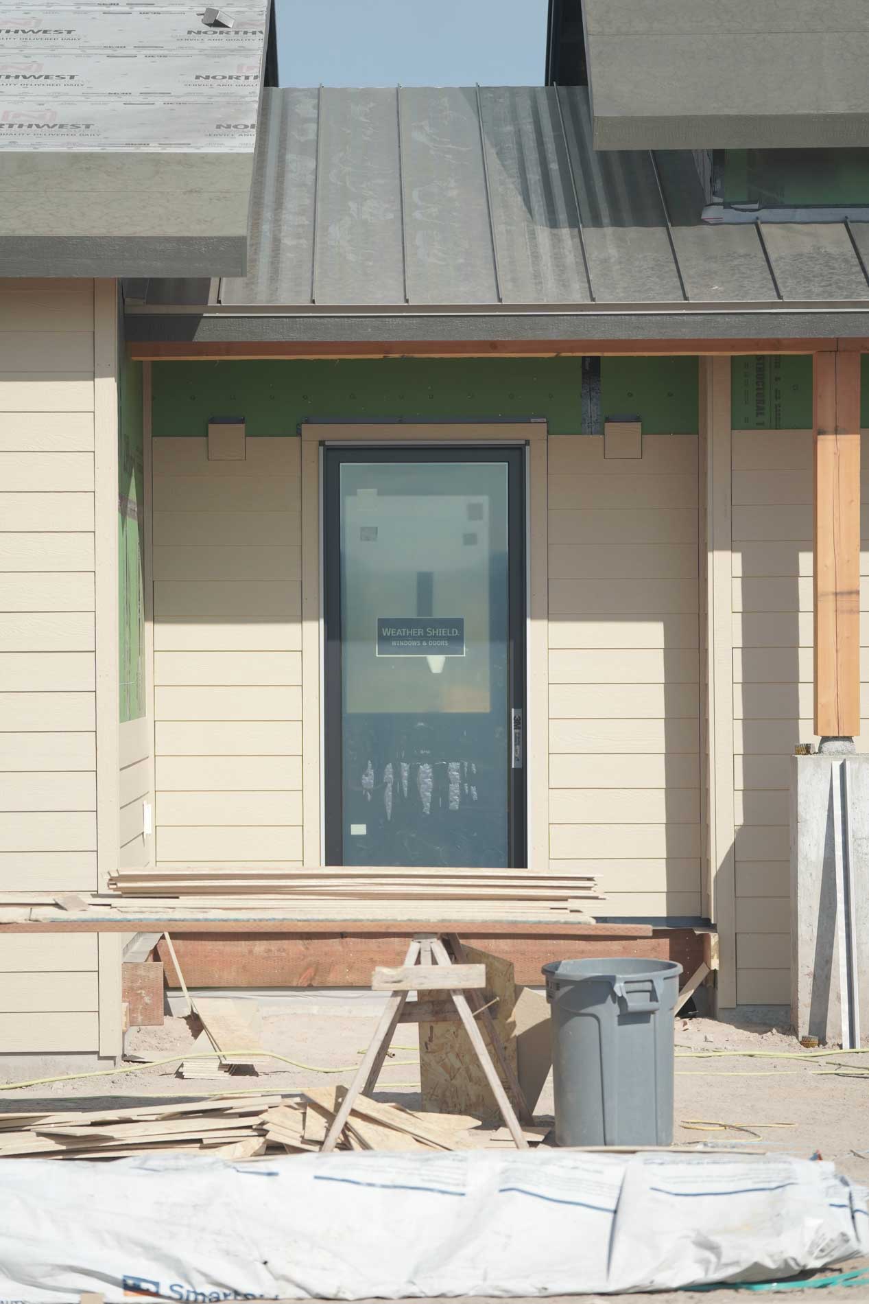 Siding Going on front door on the custom house